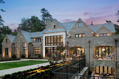 Inspiration for a huge craftsman beige three-story mixed siding house exterior remodel in Other with a clipped gable roof and a shingle roof