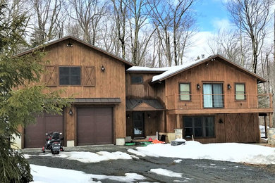 Example of a mid-sized arts and crafts attached two-car garage design in Boston