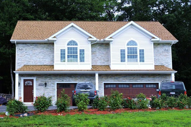 Example of a large classic detached three-car garage design in Baltimore
