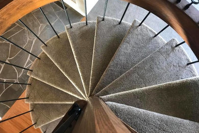 Inspiration for a small modern spiral metal railing staircase remodel in Columbus with wooden risers