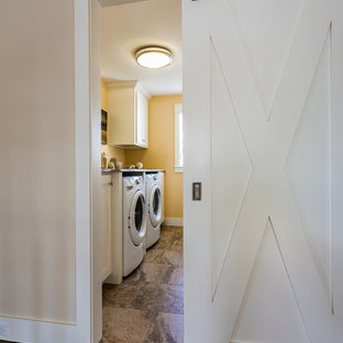 Medium sized traditional galley separated utility room in Grand Rapids with recessed-panel cabinets, white cabinets, quartz worktops, slate flooring, a side by side washer and dryer and orange walls.