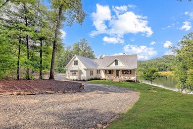 Mid-sized country white two-story wood and board and batten exterior home photo with a metal roof