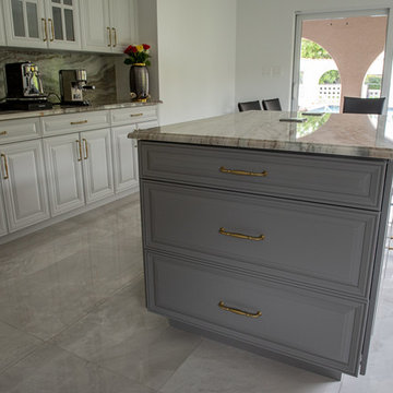 Transitional Kitchen Done in a 2 Tone Color With Integrated Dining Table