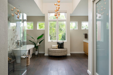 Huge trendy master porcelain tile porcelain tile, brown floor, double-sink and vaulted ceiling bathroom photo in Minneapolis with flat-panel cabinets, light wood cabinets, a one-piece toilet, beige walls, an undermount sink, quartz countertops, a hinged shower door, white countertops and a built-in vanity