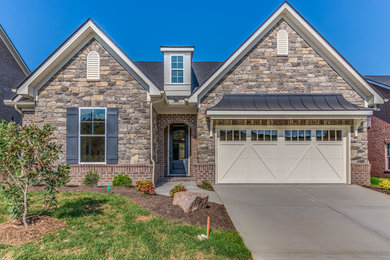 Example of a large trendy multicolored two-story brick gable roof design in Nashville