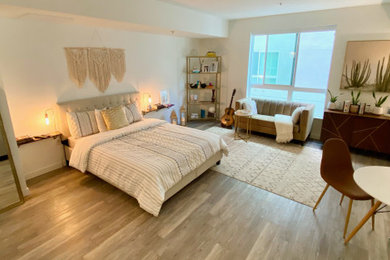 Small loft-style laminate floor and beige floor bedroom photo in Los Angeles with white walls
