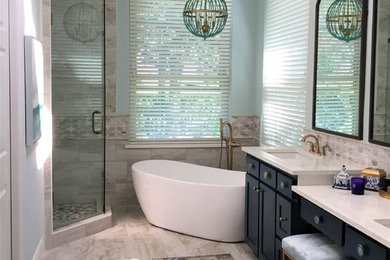 Inspiration for a large transitional master gray tile and stone tile porcelain tile and gray floor bathroom remodel in Dallas with shaker cabinets, blue cabinets, a one-piece toilet, blue walls, an undermount sink, quartzite countertops, a hinged shower door and white countertops