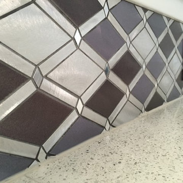 Black and White Kitchen with Stainless Steel Backsplash