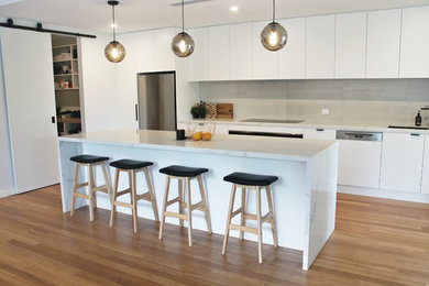 Design ideas for a contemporary kitchen in Adelaide with white cabinets and marble benchtops.