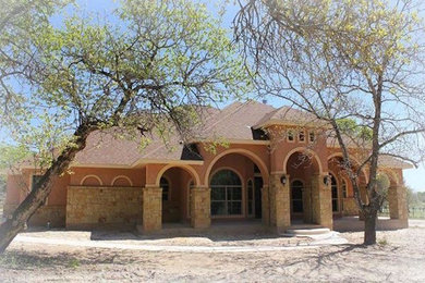 Example of a large classic brown two-story mixed siding gable roof design in Austin