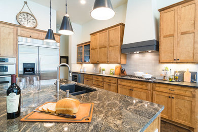 Large transitional l-shaped kitchen photo in Austin with a double-bowl sink, shaker cabinets, medium tone wood cabinets, beige backsplash, stainless steel appliances and an island