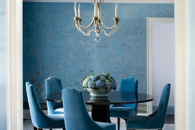 Design ideas for a large transitional separate dining room in New York with blue walls, dark hardwood floors and a standard fireplace.