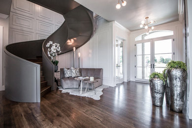 Huge transitional medium tone wood floor and brown floor entryway photo in Other with white walls and a glass front door