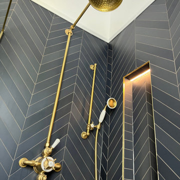 Modern Bathroom with Floral Wallpaper, Brass Fixtures & Blue Vanity