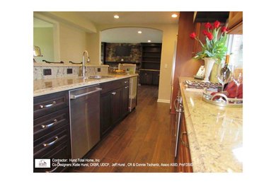 Eat-in kitchen - large transitional porcelain tile eat-in kitchen idea in Other with an undermount sink, raised-panel cabinets, dark wood cabinets, quartz countertops, beige backsplash, porcelain backsplash, stainless steel appliances and an island