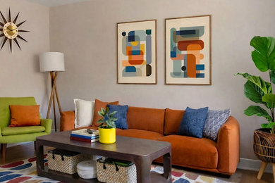 Example of a small 1960s enclosed medium tone wood floor and brown floor home theater design in New York with brown walls and a wall-mounted tv