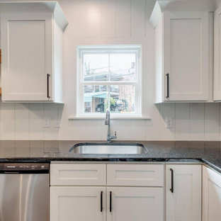 Inspiration for a large transitional u-shaped open plan kitchen in Other with an undermount sink, shaker cabinets, white cabinets, granite benchtops, white splashback, shiplap splashback, stainless steel appliances, medium hardwood floors and black benchtop.