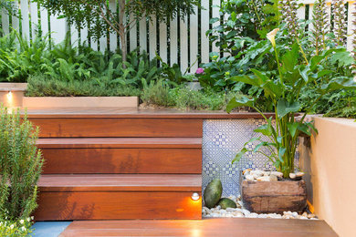 Mediterranean courtyard partial sun garden in Brisbane with a garden path and decking for summer.
