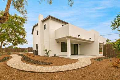 Inspiration for a mid-sized contemporary white two-story exterior home remodel in San Diego with a shingle roof