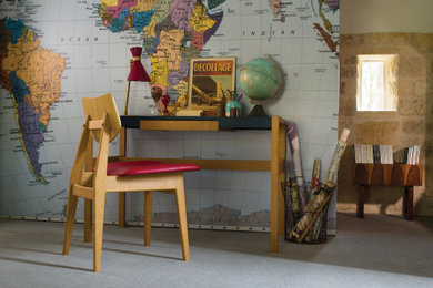 Photo of a large classic study in Other with multi-coloured walls, carpet, a freestanding desk, grey floors and brick walls.