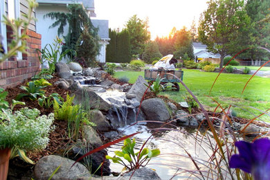 Inspiration for a mid-sized partial sun front yard pond in Seattle.