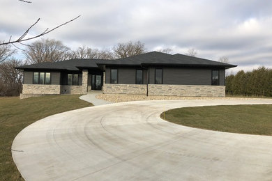 Mid-sized trendy gray one-story wood house exterior photo in Cedar Rapids with a hip roof and a shingle roof