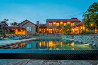 Example of a large tuscan backyard concrete and rectangular infinity hot tub design in San Francisco