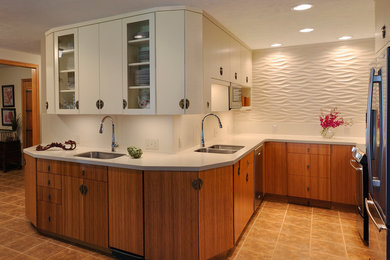 Inspiration for a small contemporary u-shaped ceramic tile and beige floor open concept kitchen remodel in Detroit with an undermount sink, flat-panel cabinets, medium tone wood cabinets, solid surface countertops, white backsplash, stainless steel appliances, no island and ceramic backsplash