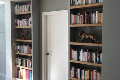 Example of a mid-sized trendy open concept medium tone wood floor living room design with gray walls