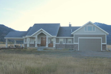 Example of a mid-sized arts and crafts gray concrete fiberboard gable roof design in Other