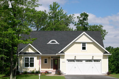 Example of a mid-sized classic beige two-story wood gable roof design in Other