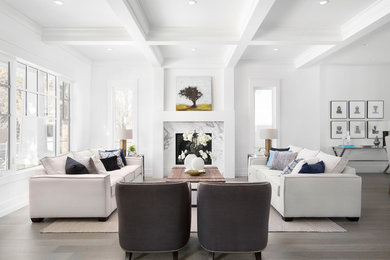Example of a transitional formal and open concept medium tone wood floor and brown floor living room design in Calgary with white walls, a standard fireplace and a stone fireplace