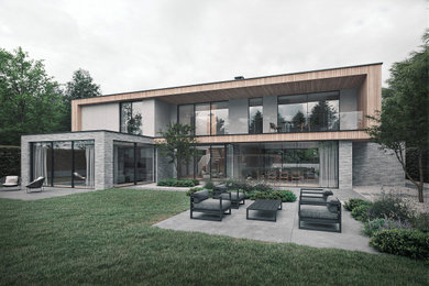 Ejemplo de fachada de casa contemporánea grande de dos plantas con revestimientos combinados, tejado plano y techo verde