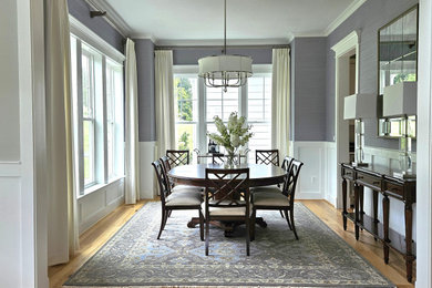 Mid-sized transitional medium tone wood floor and wallpaper enclosed dining room photo in DC Metro with blue walls