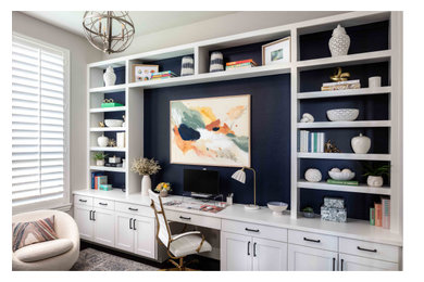 Inspiration for a mid-sized contemporary built-in desk home office remodel in Houston with blue walls