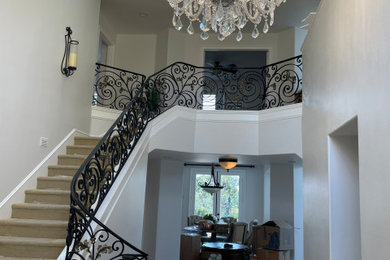 Inspiration for a large timeless foyer remodel in Orange County with white walls and a black front door