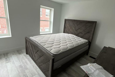Bedroom - mid-sized contemporary master laminate floor and gray floor bedroom idea in Philadelphia with beige walls
