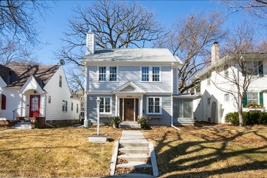 Mid-sized traditional blue two-story vinyl exterior home idea in Minneapolis with a tile roof