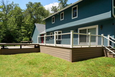 Large minimalist backyard ground level deck photo in Philadelphia with no cover