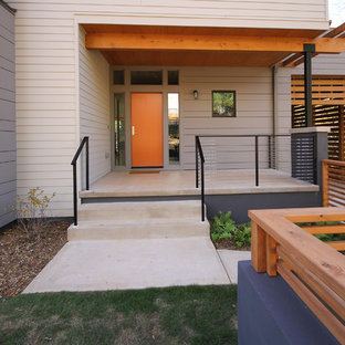 Ispirazione per una piccola porta d'ingresso minimal con una porta singola e una porta arancione