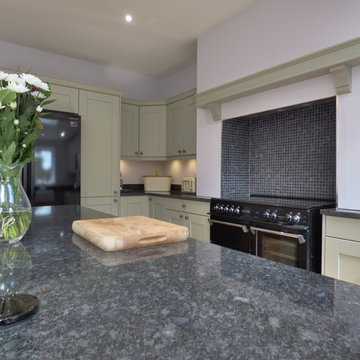 sage green painted shaker in large open plan kitchen