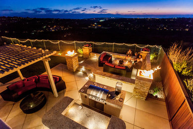 Design ideas for a mid-sized coastal full sun backyard stone landscaping in San Diego.