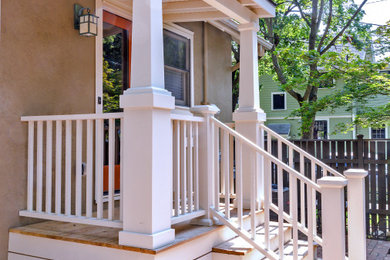 Mid-sized arts and crafts concrete paver mixed material railing porch idea in Detroit with a roof extension