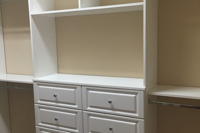 Inspiration for a large contemporary gender-neutral carpeted walk-in closet remodel with shaker cabinets and white cabinets