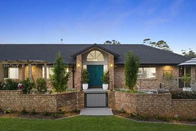 Mid-sized traditional front yard full sun formal garden in Gold Coast - Tweed with with a gate.