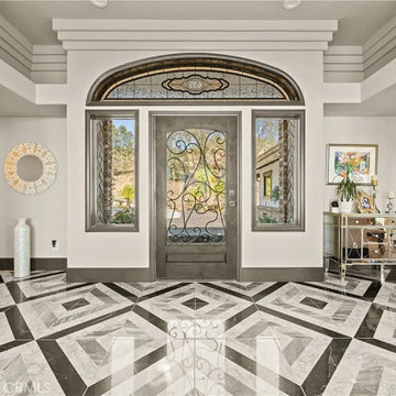 Grand Foyer with Geometric Marble Tile and Stained Glass