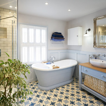 Wood panelled main bathroom with encaustic flooring and large shower