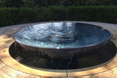 Photo of a mid-sized contemporary shade backyard concrete paver water fountain landscape in San Francisco.