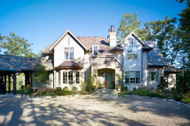 Inspiration for a large timeless beige two-story mixed siding exterior home remodel in Other