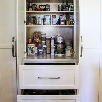 White Kitchen with Gray Quartz Countertops, Farmhouse Sink and Hardwood Floors